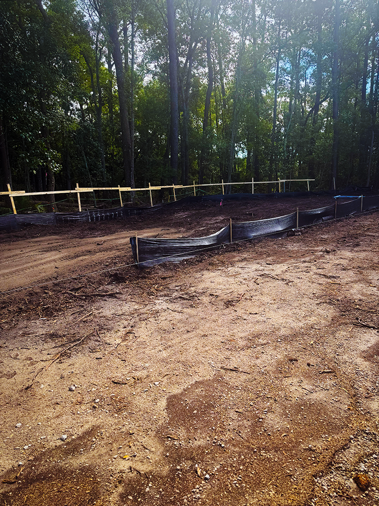Site preparation area with clearing limits and erosion-control fencing